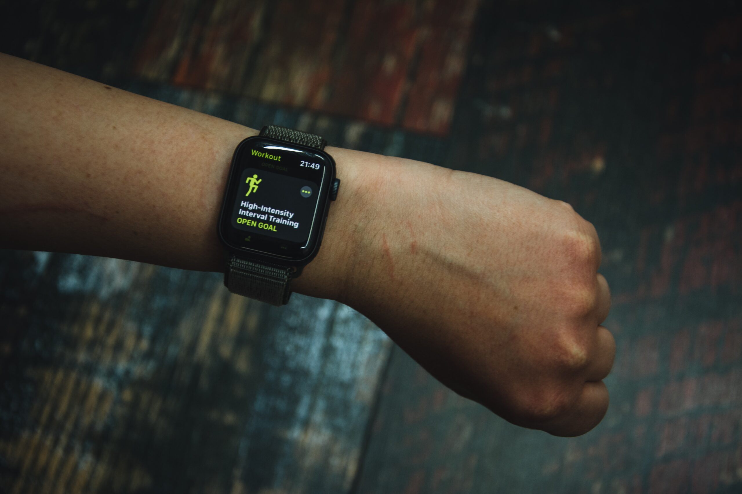 A black smartwatch worn on a user's wrist displays exercise data